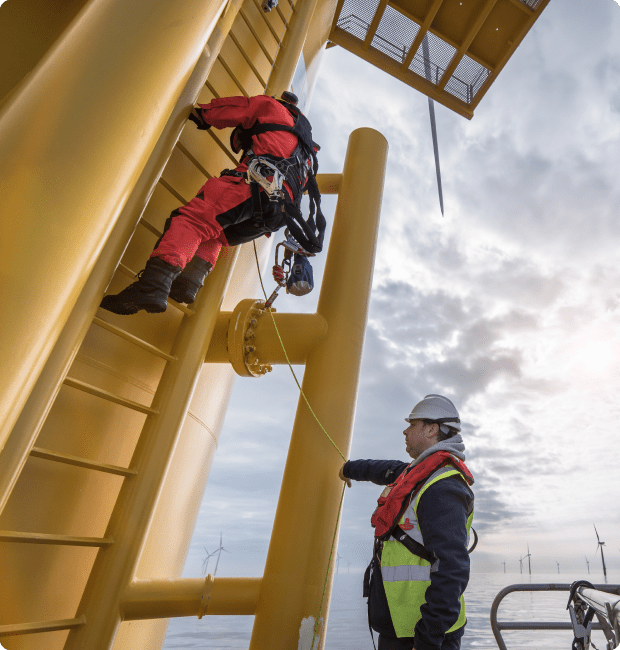 Team at work on a floating turbine, contributing to the wind network.